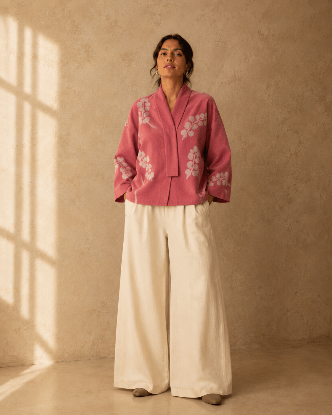 Nuno Milano Lightweight Dusty Rose Blossom Kimono Jacket, front view, with hand-felted white blossom motif on dusty rose felted Merino wool, open shawl collar, styled with cream wide-leg trousers