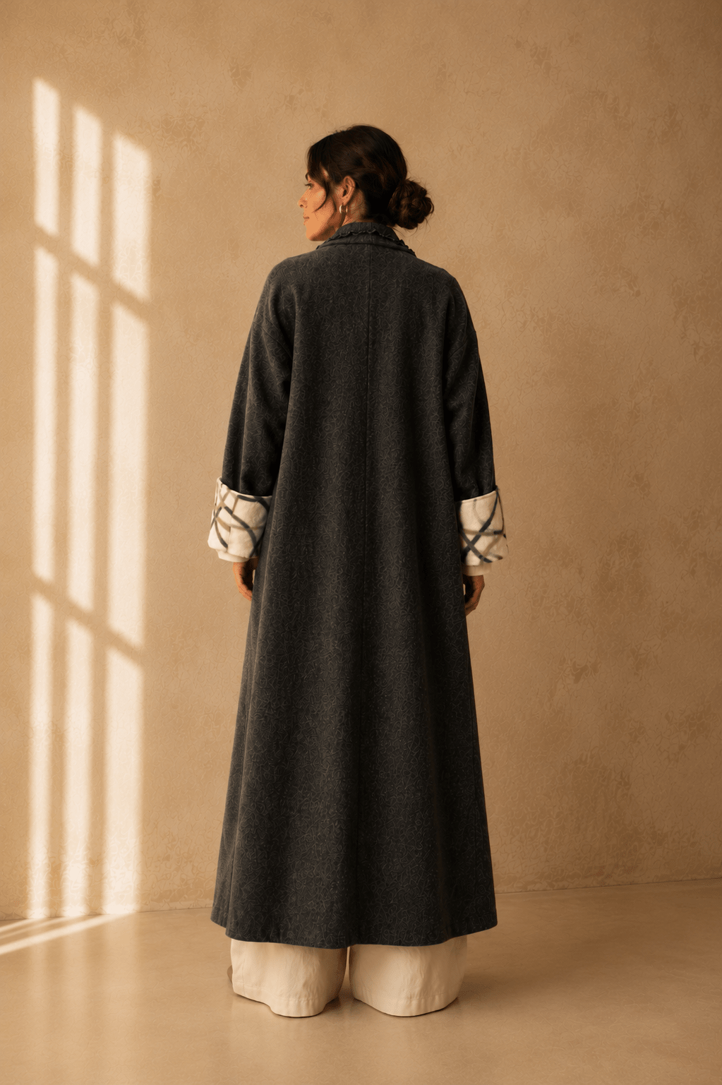 Nuno Milano dark charcoal felted Merino wool robe coat, back view, full length silhouette with contrasting cream and green cuffs
