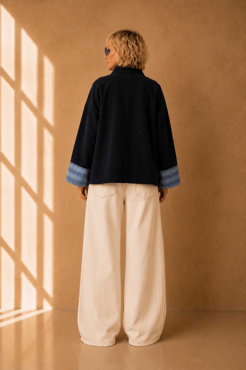 Nuno Milano Aki navy felted Merino wool jacket, back view, cropped length with wide contrasting light blue striped cuffs