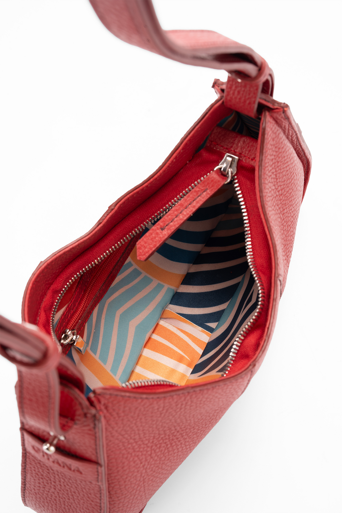 A close-up of a red textured leather handbag shown open, revealing a colorful striped interior lining with navy, orange, and light blue wavy patterns. The brand name 'Gitana' is subtly embossed on the lower left corner of the red leather.