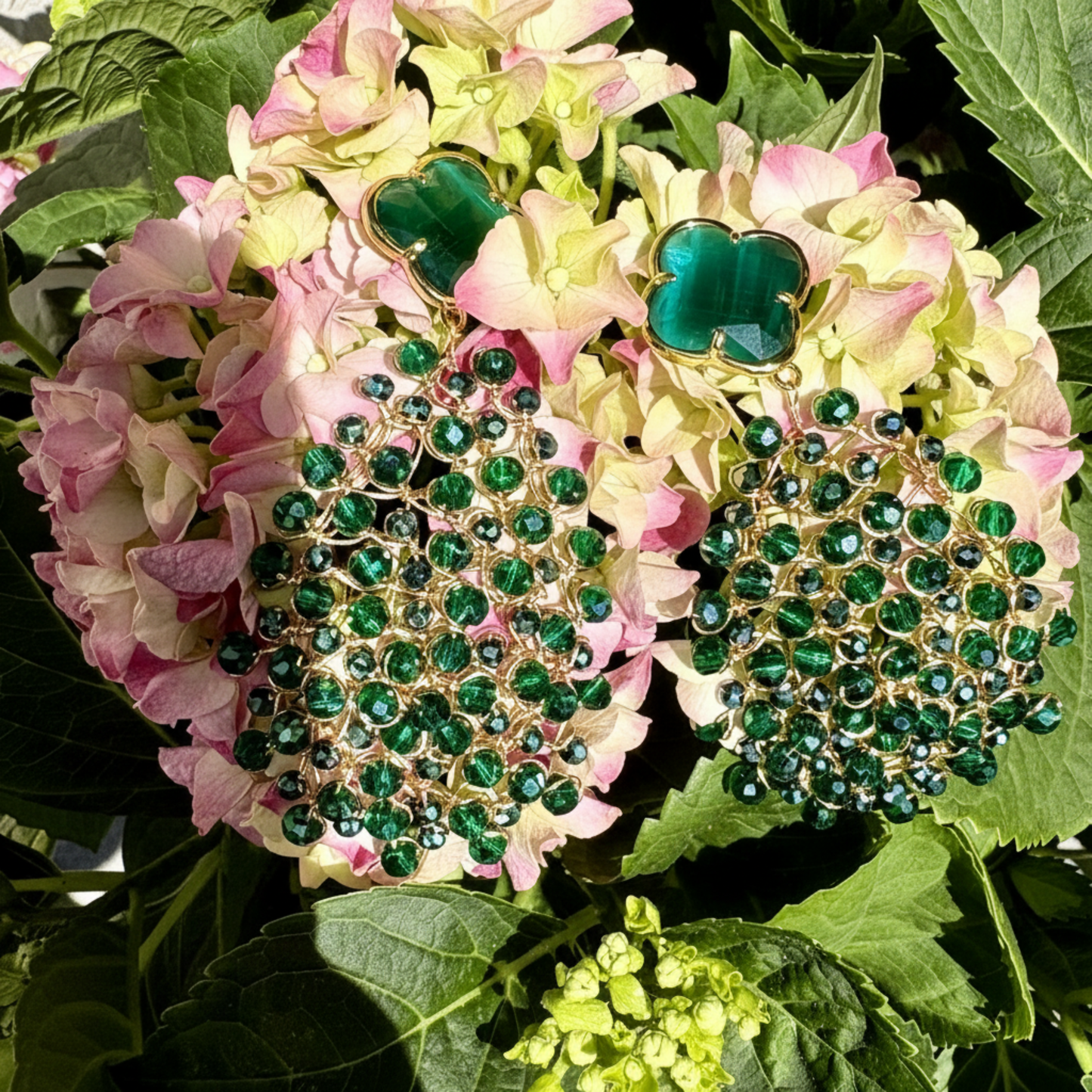 Clover Leaf Mandala earrings handcrafted with 18kt gold-plated copper wire and faceted crystals in emerald green, with a faceted clover-shaped crystal top and gold-plated brass fittings