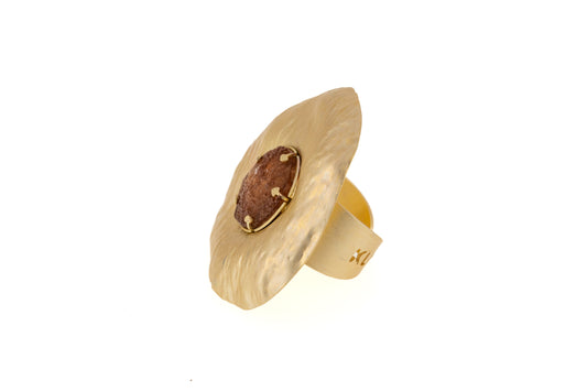 Sun Resin Ring in matt gold with brown resin centre, angled side view showing the adjustable brass band and sculptural disc shape on white background