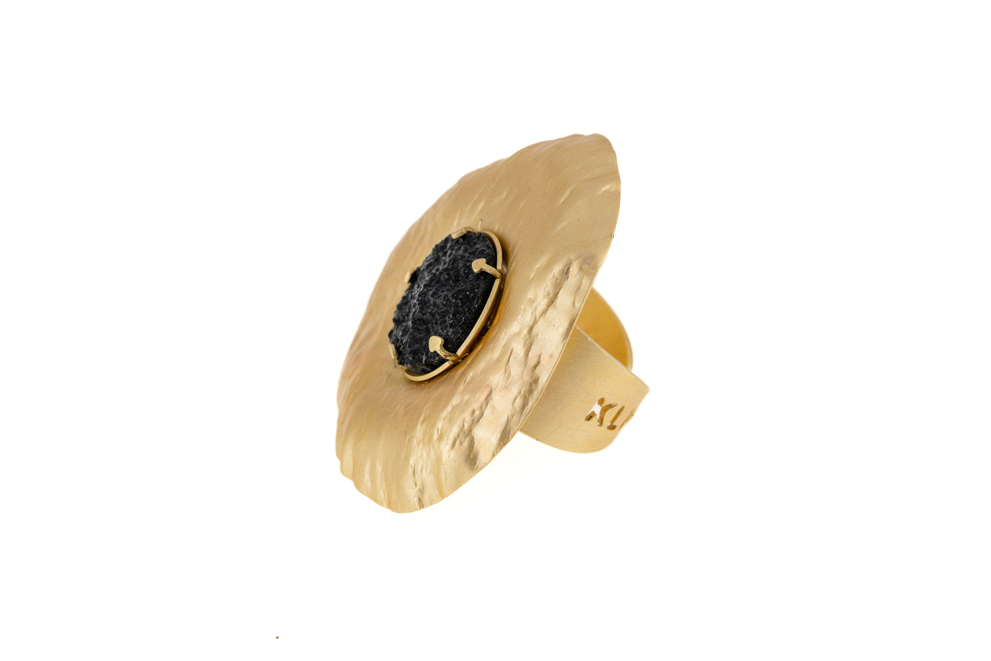 Sun Resin Ring in matt gold with black resin centre, angled side view showing the adjustable brass band and sculptural disc shape on white background