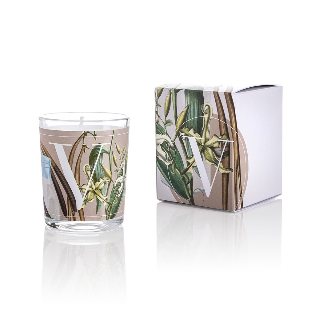 Cereria Pernici Elementi Vanilla & Milk 70g scented candle in a clear glass tumbler with full-wrap botanical vanilla pod and flower illustration on a warm taupe background, shown alongside its matching gift box, product shot on white background