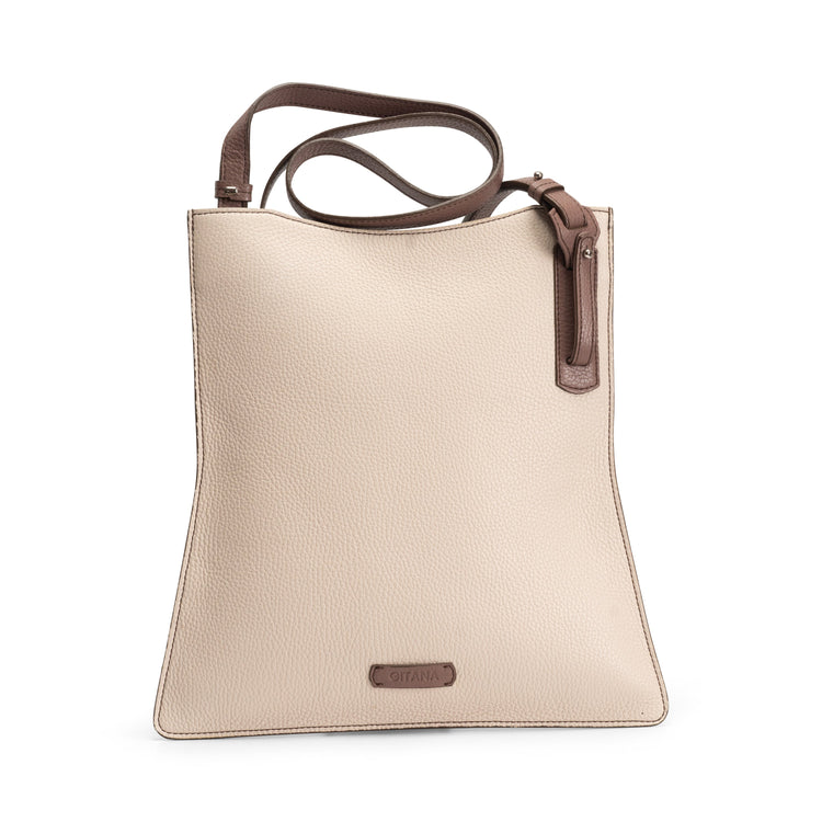 The front view of a red luxury calf crossbody bag with the shoulder strap coiled on the left hand corner.