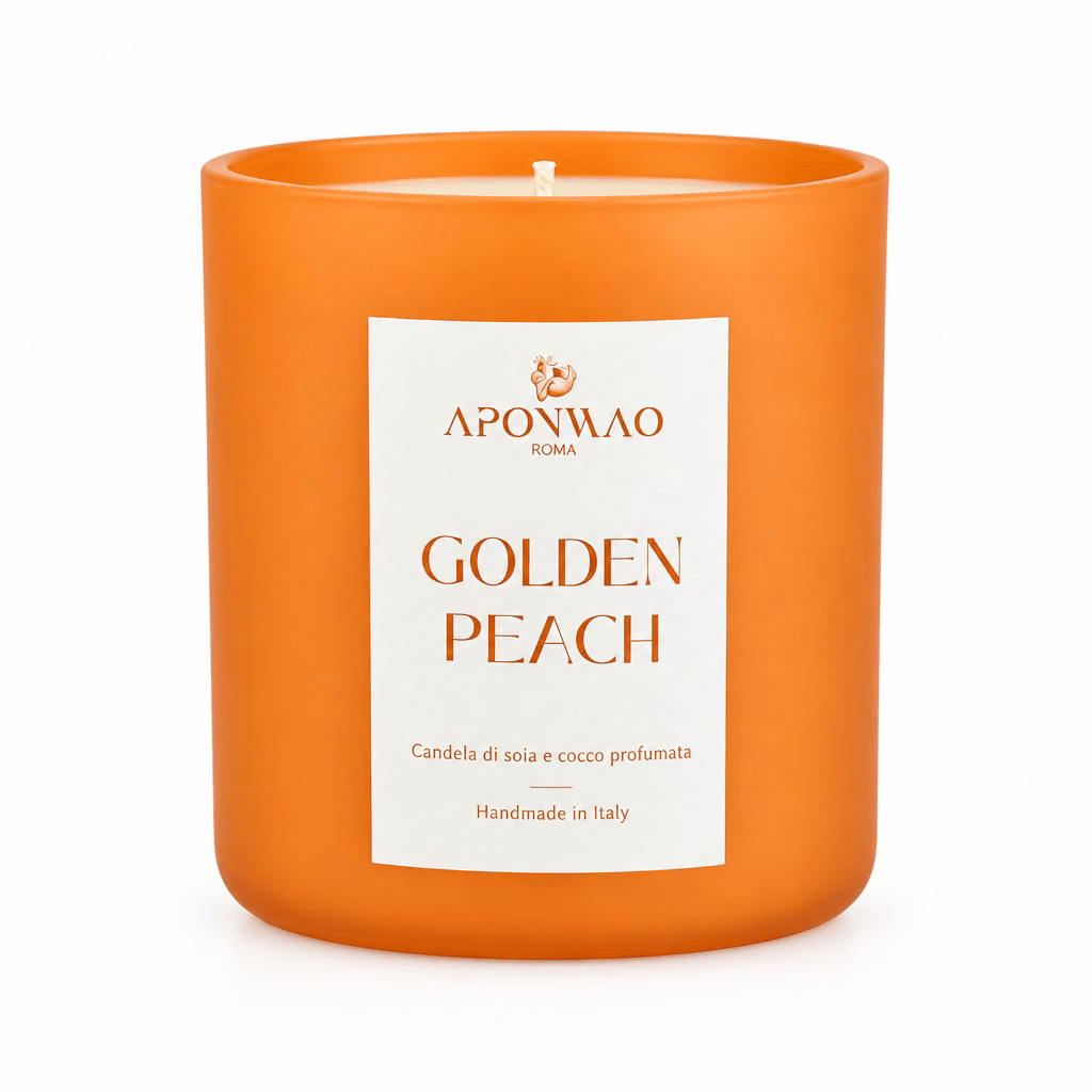 An orange scented candle in a matte orange glass jar with a white label reading 'APONWAO ROMA GOLDEN PEACH' against a white background.