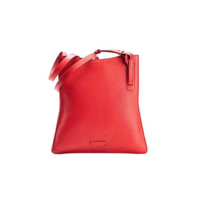 The front view of a red luxury calf crossbody bag with the shoulder strap coiled on the left hand corner.