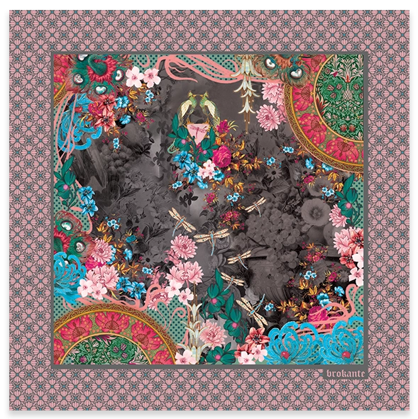 Camélia Anthracite cashmere and modal square scarf laid out flat, with pink camellias, red roses, turquoise flowers, golden dragonflies and two small birds on a smoky charcoal-grey floral centre, coral and gold half medallions in two corners, and a pink border with a grey floral lattice pattern.