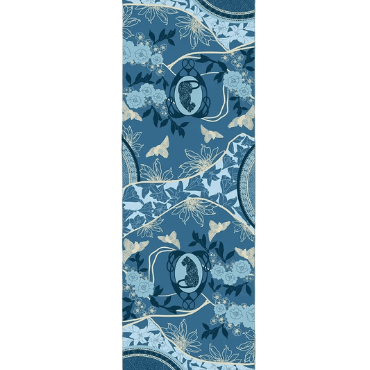 Leopard Azure cashmere scarf print shown flat, with two spotted leopards in pale blue Art Nouveau oval frames, powder-blue roses, lilies, cream star-shaped flowers and golden-cream birds on rolling denim-blue hills outlined in cream, with mosaic medallions at the edges.