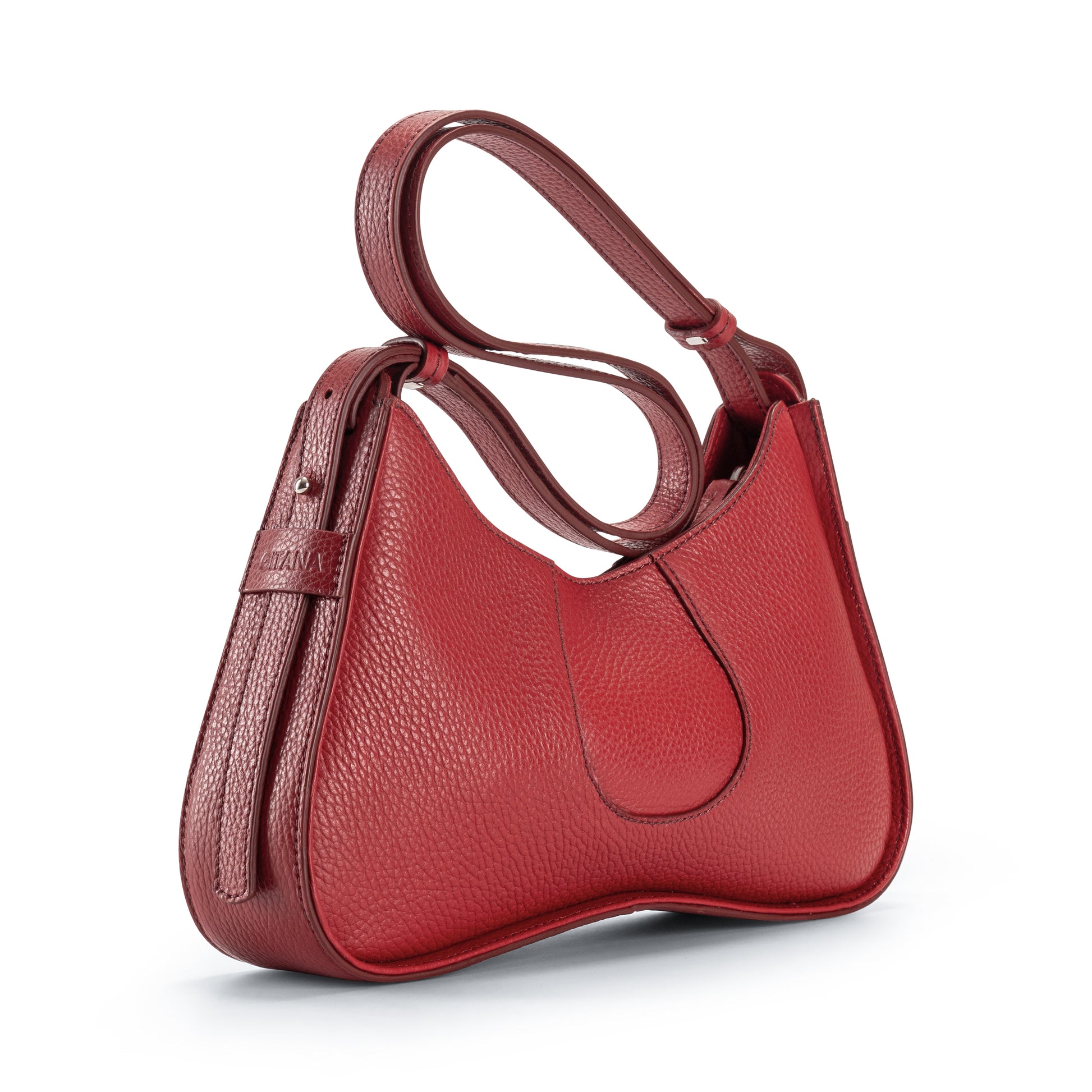 Close-up of Aria Shoulder Bag in Red Italian Pebble Leather focusing on the Ad- Side Viewustable Shoulder Strap and Gitana" Branding.