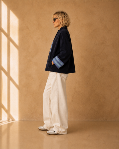 Nuno Milano Aki navy felted Merino wool jacket, side view, showing wide contrasting light blue turned-back cuffs and relaxed cropped silhouette