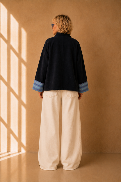 Nuno Milano Aki navy felted Merino wool jacket, back view, cropped length with wide contrasting light blue striped cuffs