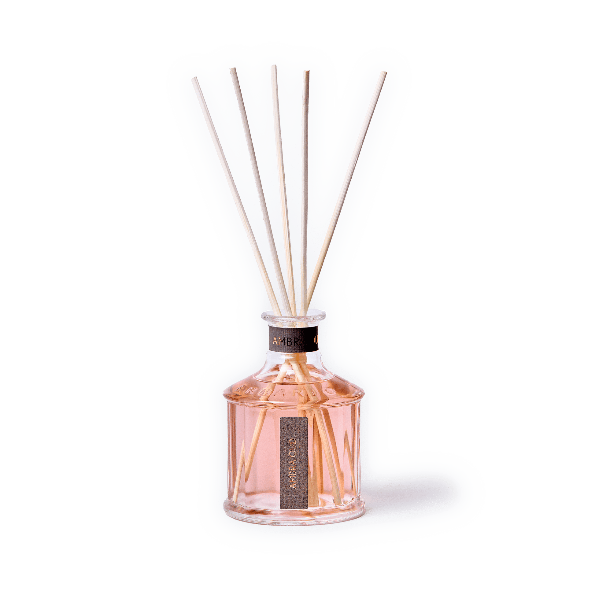 A reed diffuser bottle filled with pale pink liquid, featuring six natural reed sticks extending upward. The bottle is clear glass with a black collar and a vertical black label reading 'ARENO 00'.