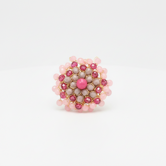 A light pink, dark pink and grey swarovsky crystal Mandala design ring on a white background.