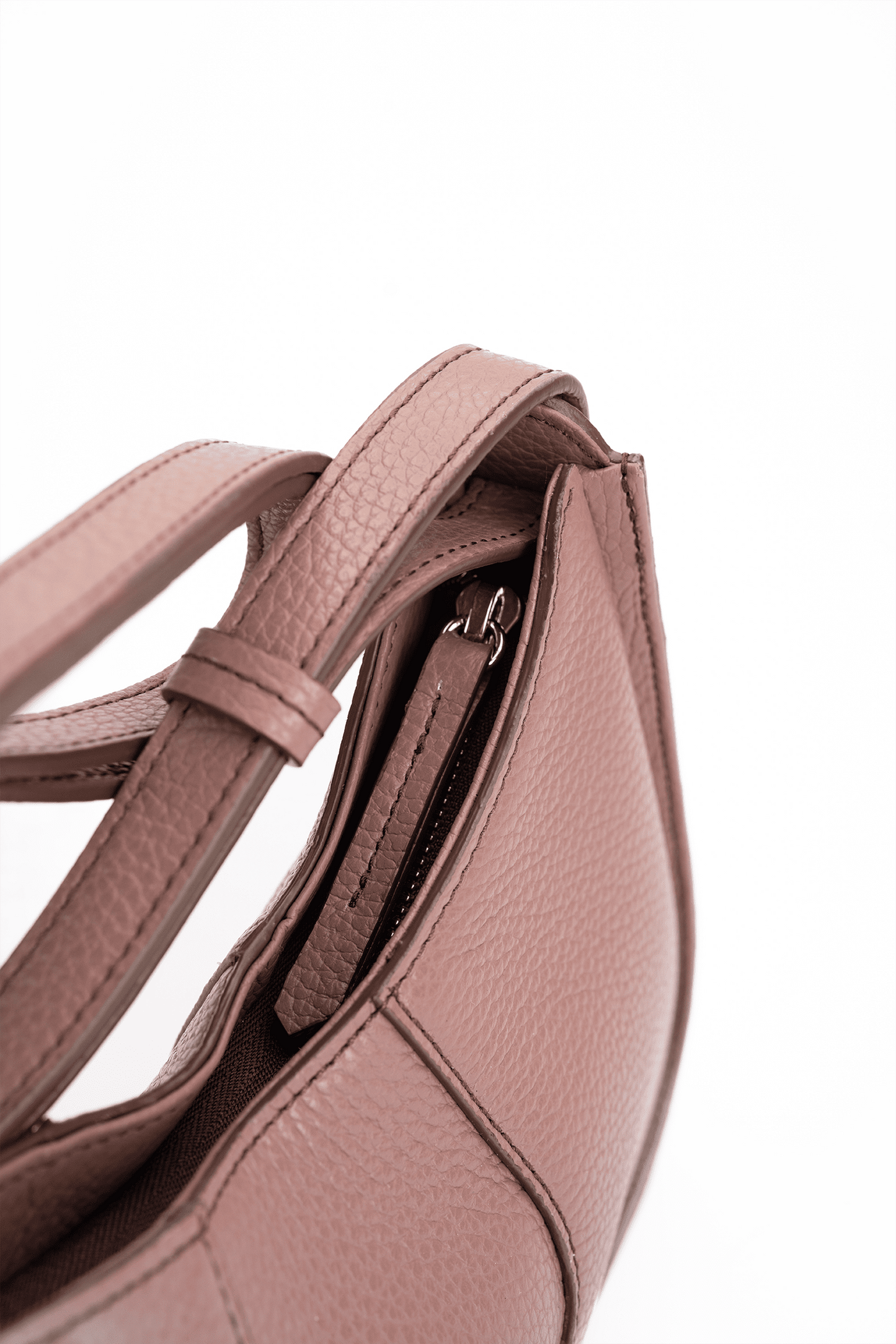 Close-up of a toast brown handbag with a strap on a white background