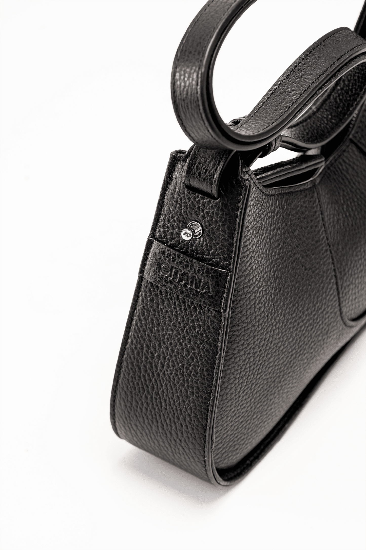 The Side View of a Black Italian Pebble Leather Handbag with a visible "Gitana" Brand Tag.