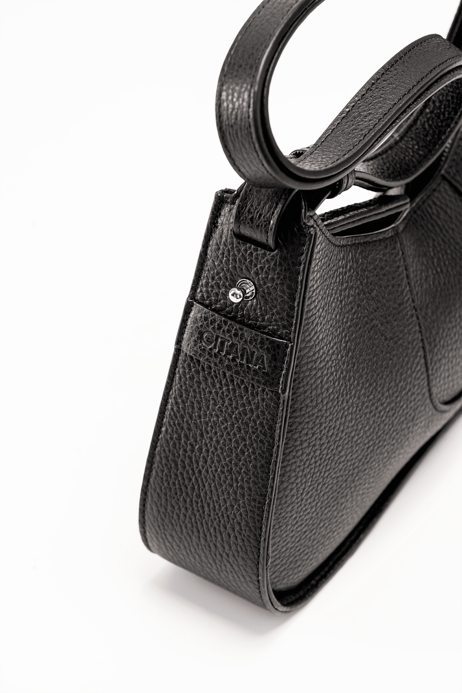 The Side View of a Black Italian Pebble Leather Handbag with a visible "Gitana" Brand Tag.