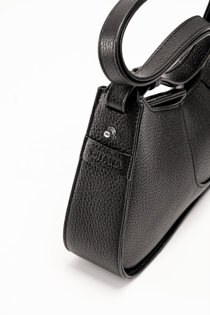 The Side View of a Black Italian Pebble Leather Handbag with a visible "Gitana" Brand Tag.