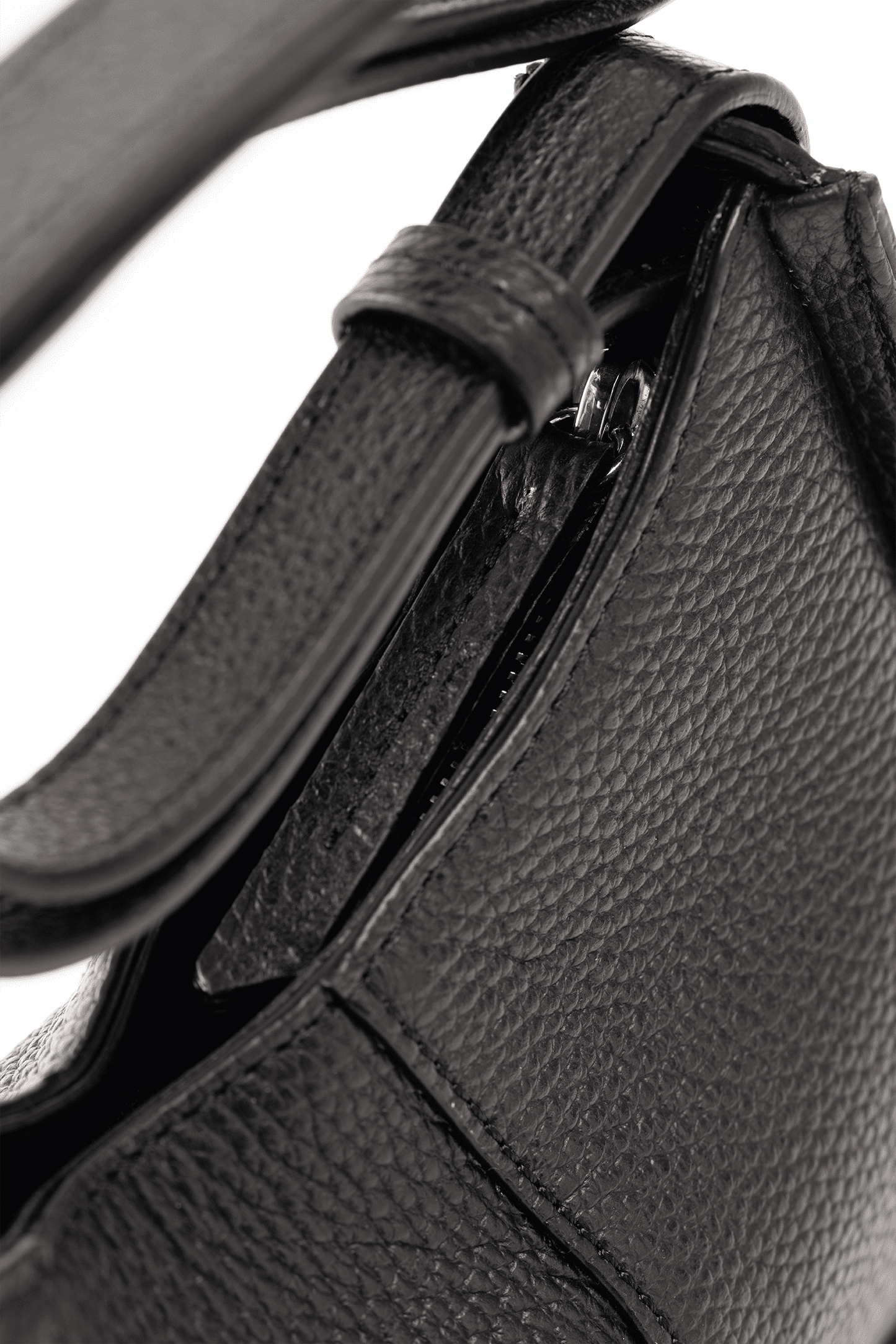 Close-up of a Black Italian Pebble Calf Leather handbag with Focus on a handle.