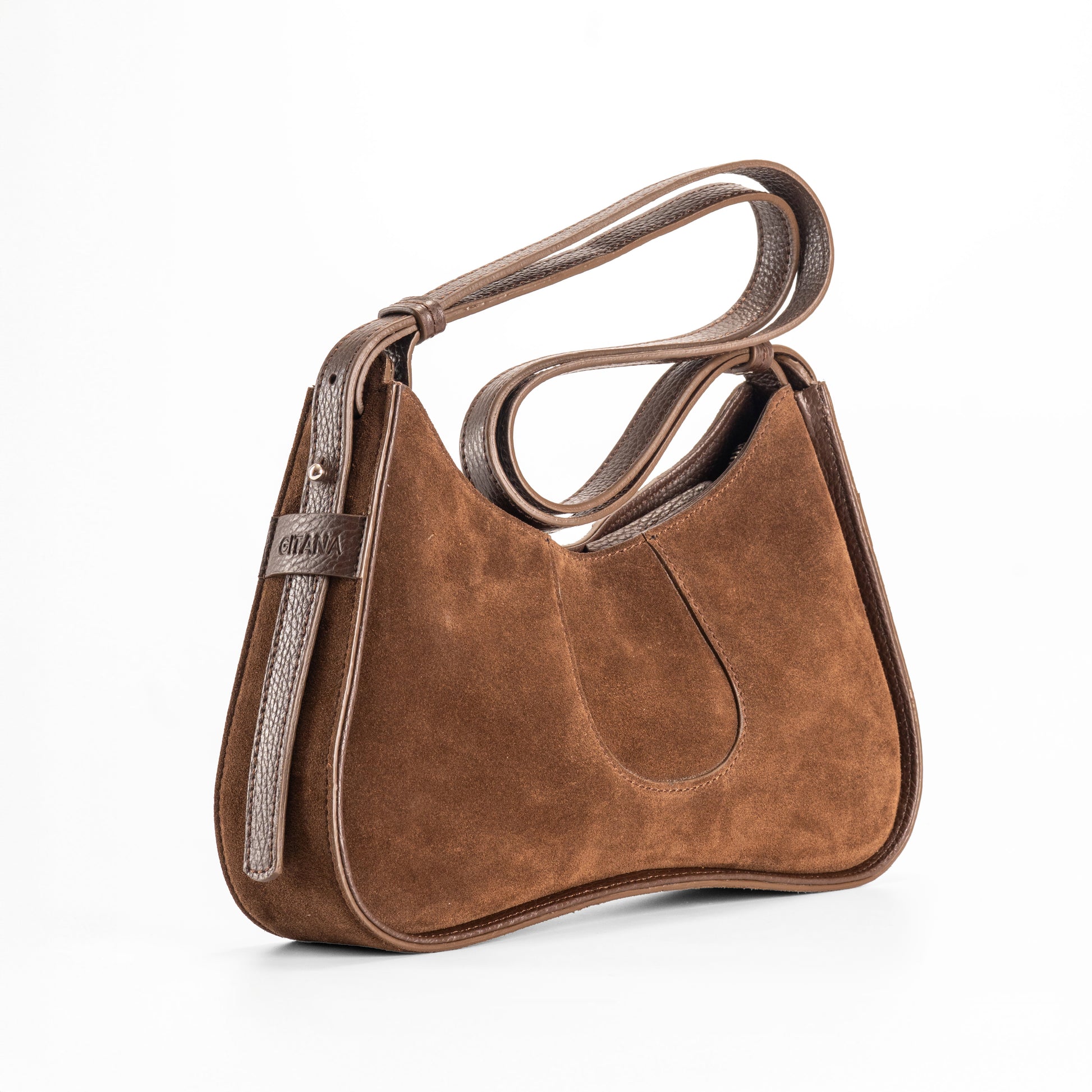 Side View of a Brown Italian Suede Leather Handbag with a folded strap.  Focus is Placed on the Adjustable Shoulder Strap.