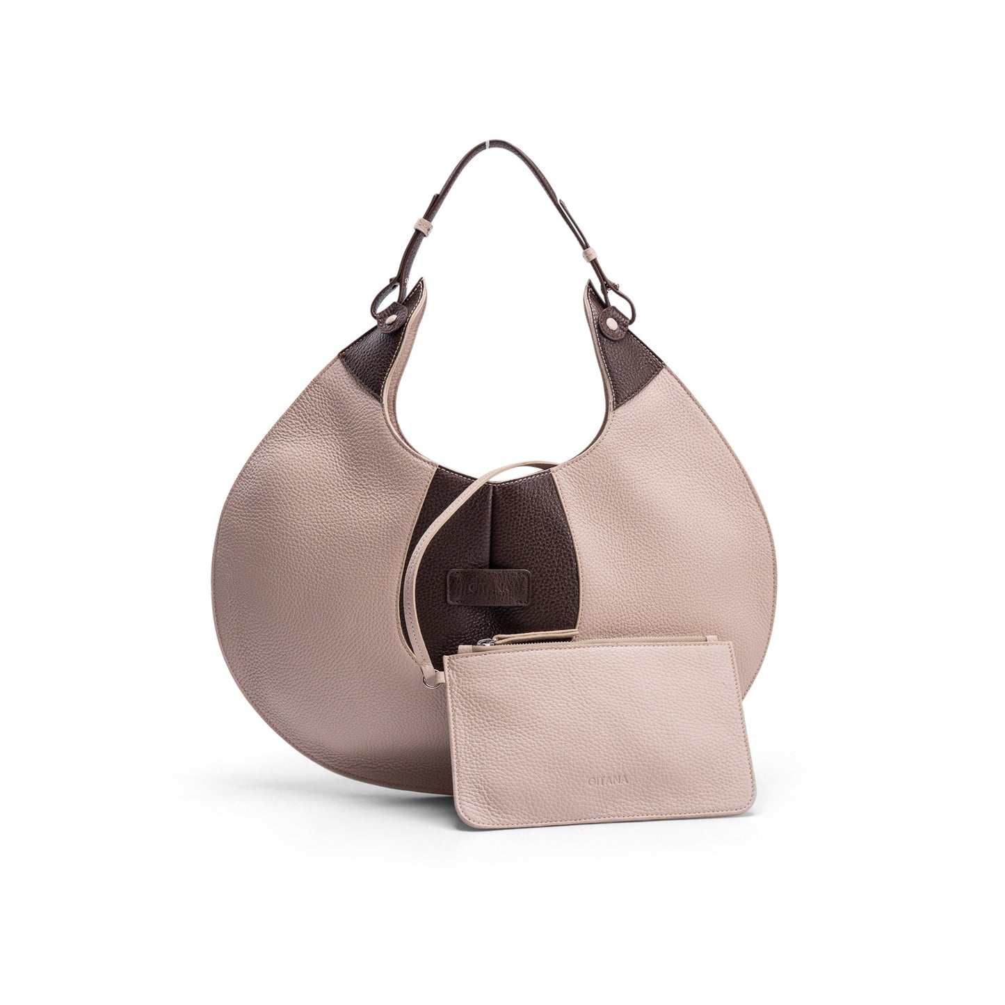The front view of a luxury cream and brown elliptical leather tote bag showcased  on a white background.  There is a matching pouch attached by a removable strap.
