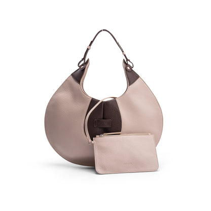 The front view of a luxury cream and brown elliptical leather tote bag showcased  on a white background.  There is a matching pouch attached by a removable strap.