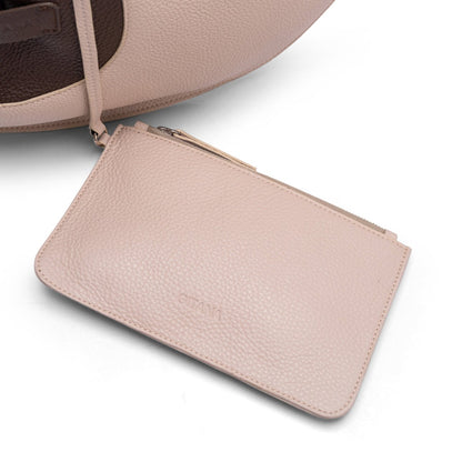 A beige leather pouch attached to a tote bag styled on a white background.
