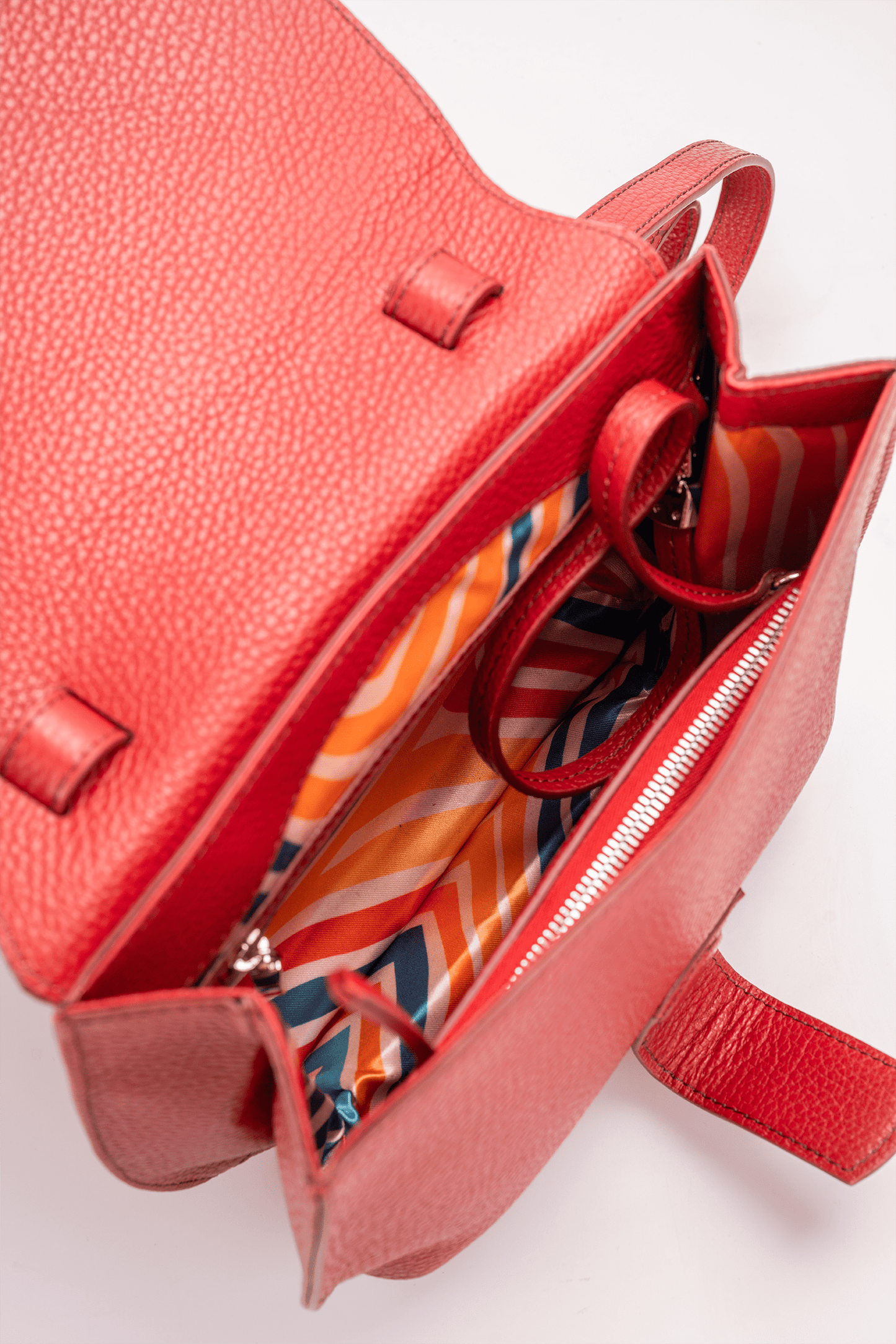 Yara Crossbody Bag in Red Italian Pebble Calf Leather - Interior Compartment Detail and colourful geometric lining.