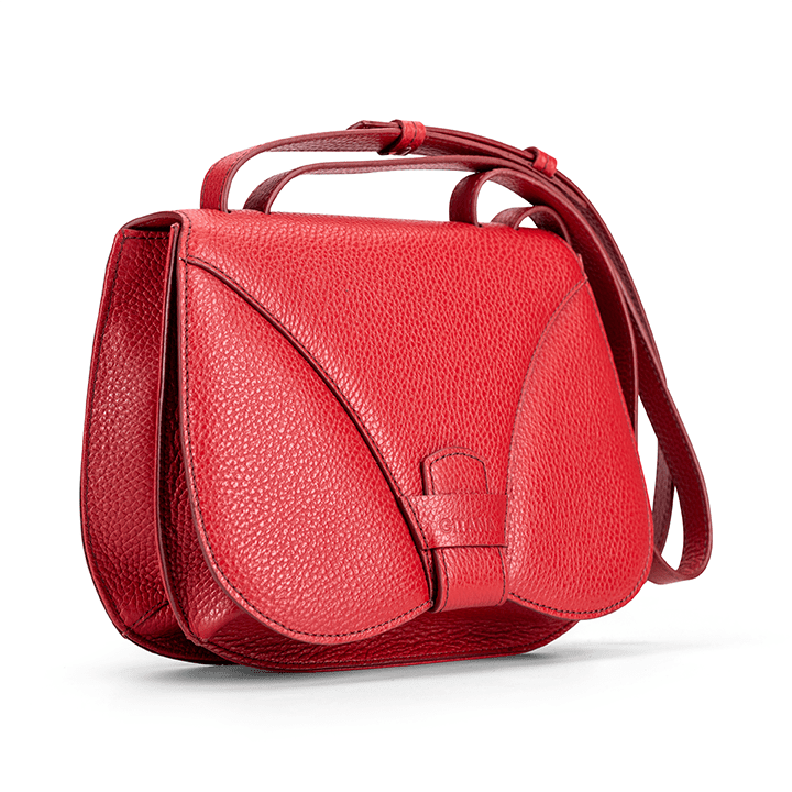 Side view of a designer luxury medium-sized red calf Italian pebble leather women’s handbag.