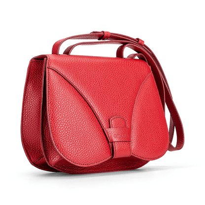 Side view of a designer luxury medium-sized red calf Italian pebble leather women’s handbag.