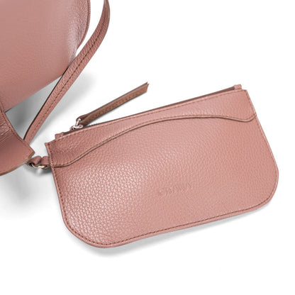 Close-up of a light brown leather designer pouch attached to a luxury handbag by a strap, showcasing the visible brand name.