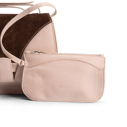 A front view of a luxury crossbody bag in beige calf leather and matching pouch on attaching strap.