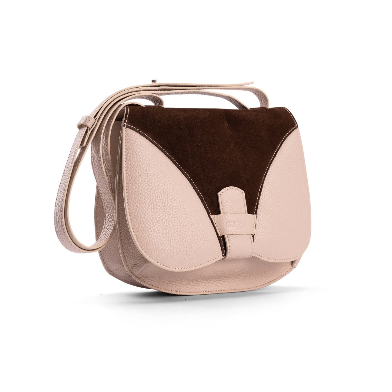 Side view of a medium-sized beige calf leather luxury women’s handbag with a beige and chocolate suede trim flap, designer leather bag.