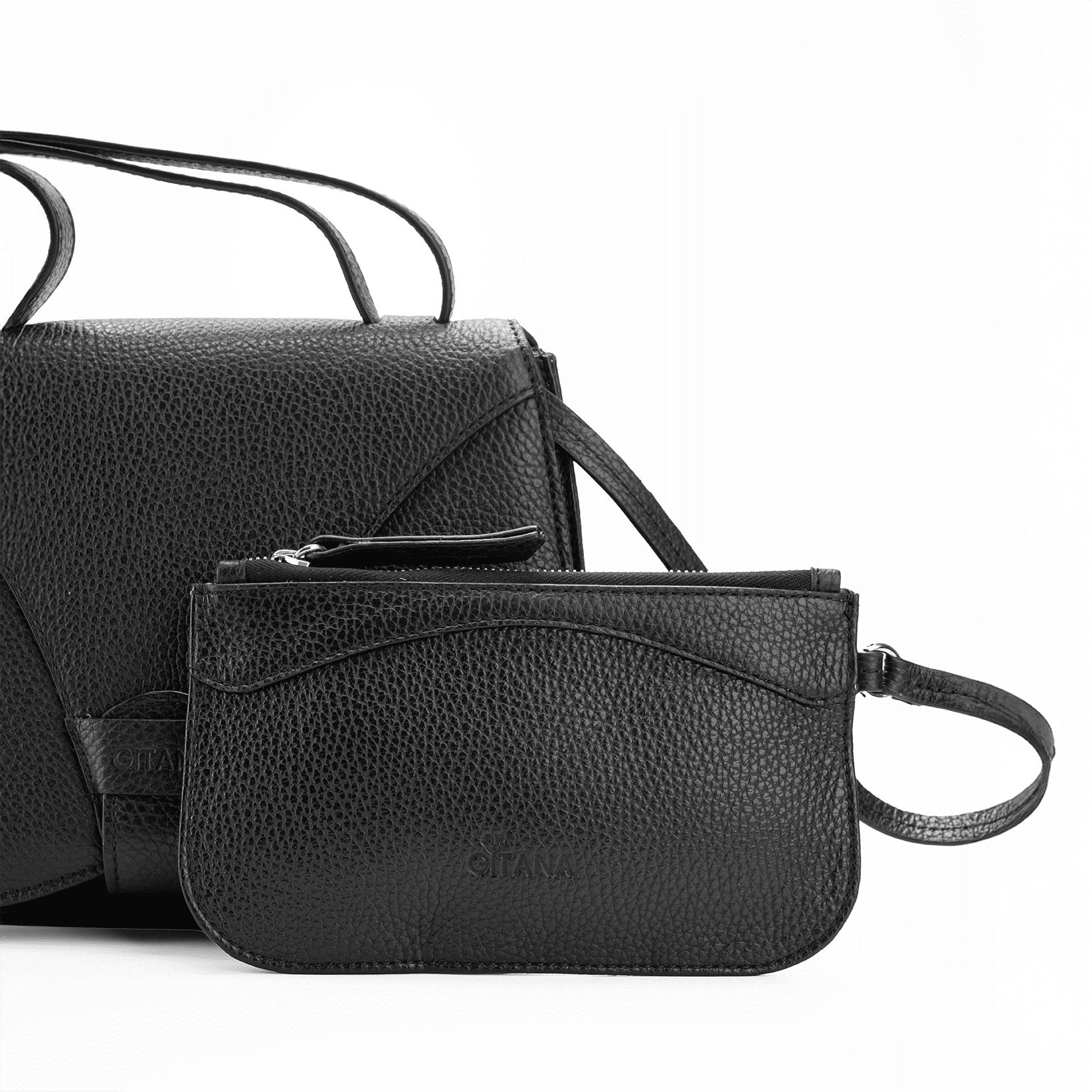 Close-up of a black Italian pebble calf leather designer pouch attached to a luxury handbag by a strap, showcasing the visible brand name 