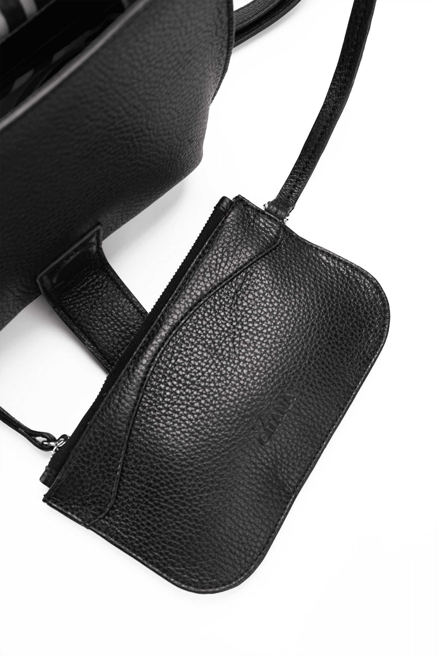 Close-up of a black leather designer pouch attached to a luxury handbag by a strap, showcasing the visible brand name.