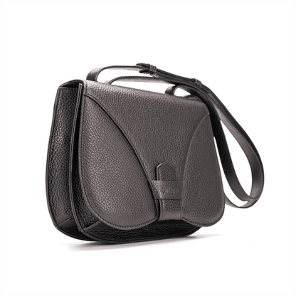 Side view of a designer luxury medium-sized black Italian pebble calf leather women’s handbag.