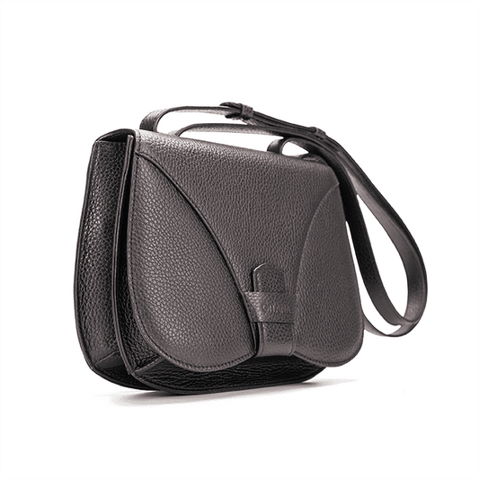 Side view of a designer luxury medium-sized black Italian pebble calf leather women’s handbag.