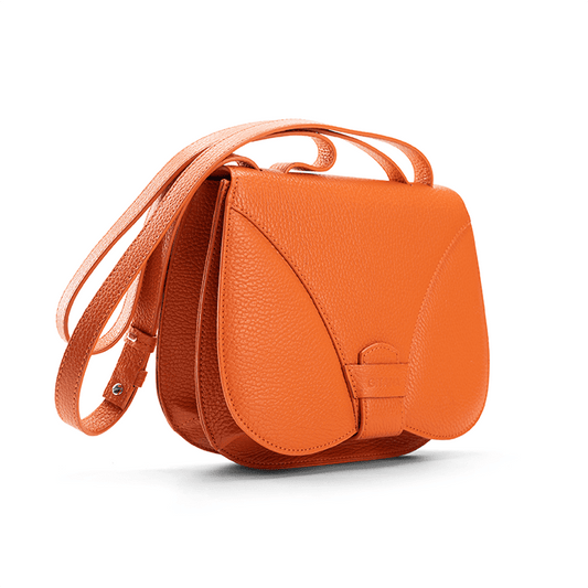 Side view of a designer luxury medium-sized orange Italian pebble calf leather women’s handbag.