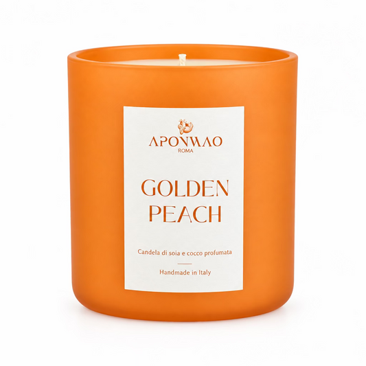 An orange scented candle in a matte orange glass jar with a white label reading 'APONWAO ROMA GOLDEN PEACH' against a white background.
