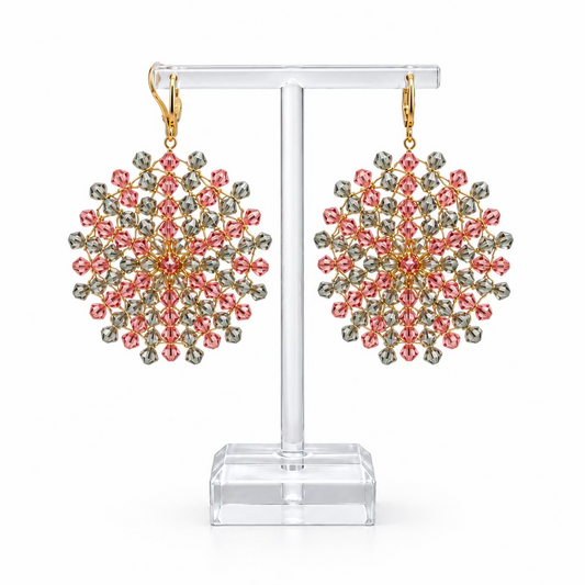 A pair of Mandala earrings with pink and grey/green Swarovsky crystal earrings threaded on gold plated thread on a white background.