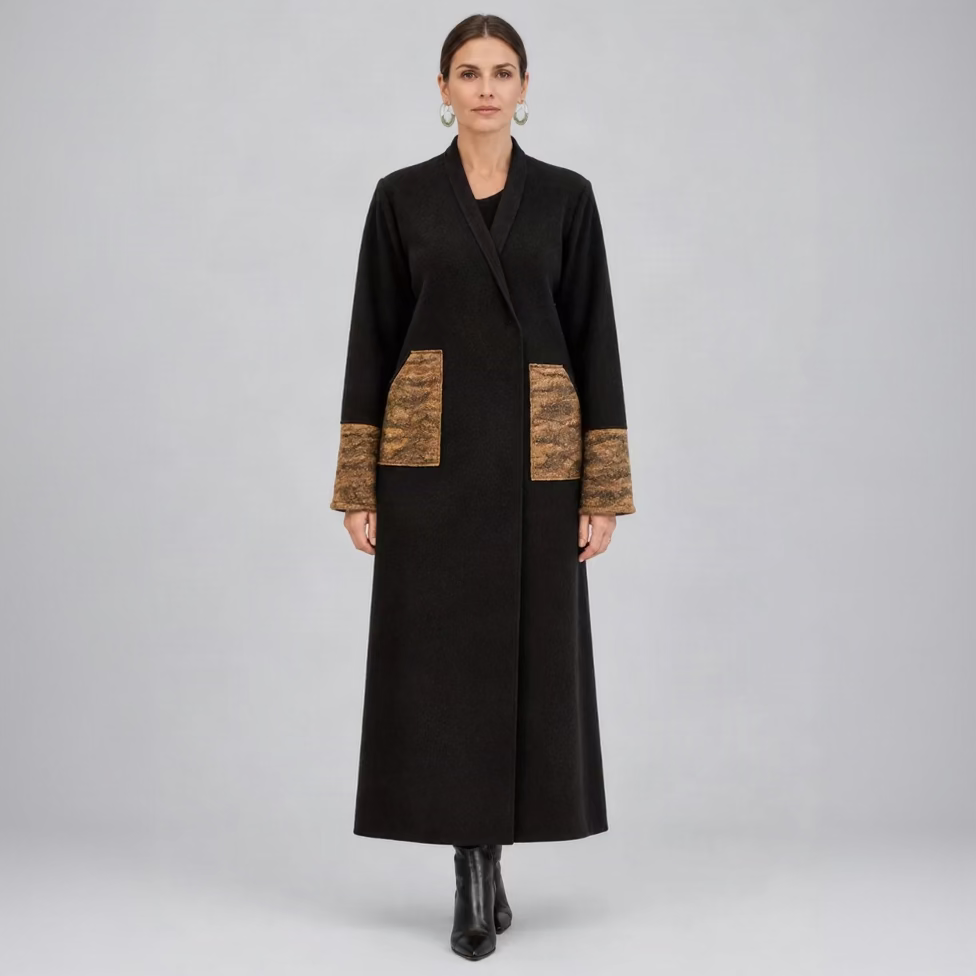 A woman wearing a dark brown wool coat with marbled caramel pocket and cuff details