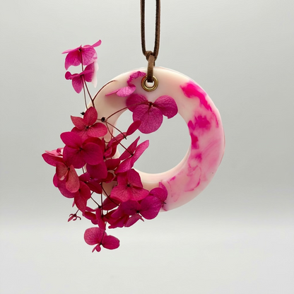 A Rose Bloom  scented cupboard wax tablet with a leather string on a white background
