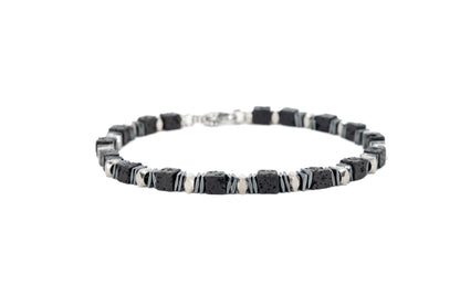 Men's bracelet with square black lava stone beads and polished stainless steel accents, with lobster clasp fastening on white background