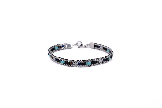 Men's woven stainless steel chain bracelet with turquoise and black stone tile accents and lobster clasp fastening on white background