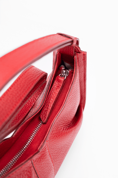 Close-up view of the zip detail of a luxury Italian pebble leather shoulder bag