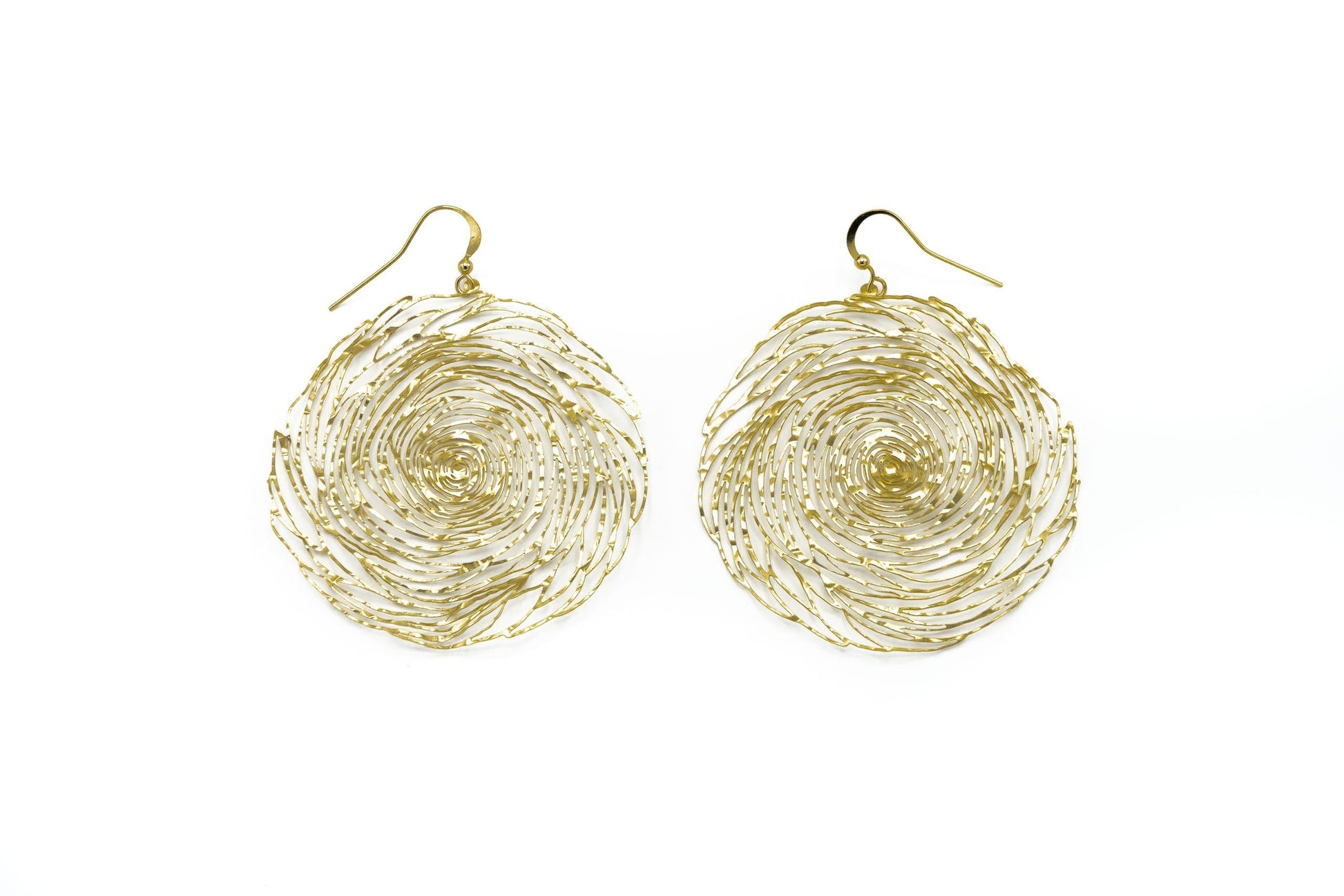 Large round brass wire spiral filigree drop earrings with gold hook fastening on white background