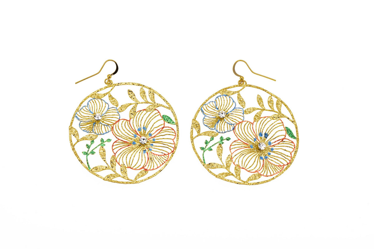 Large round brass drop earrings with openwork floral design, hand-painted enamel in blue, coral and green, crystal centres and gold hook fastening on white background