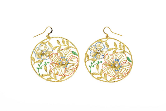 Large round brass drop earrings with openwork floral design, hand-painted enamel in blue, coral and green, crystal centres and gold hook fastening on white background
