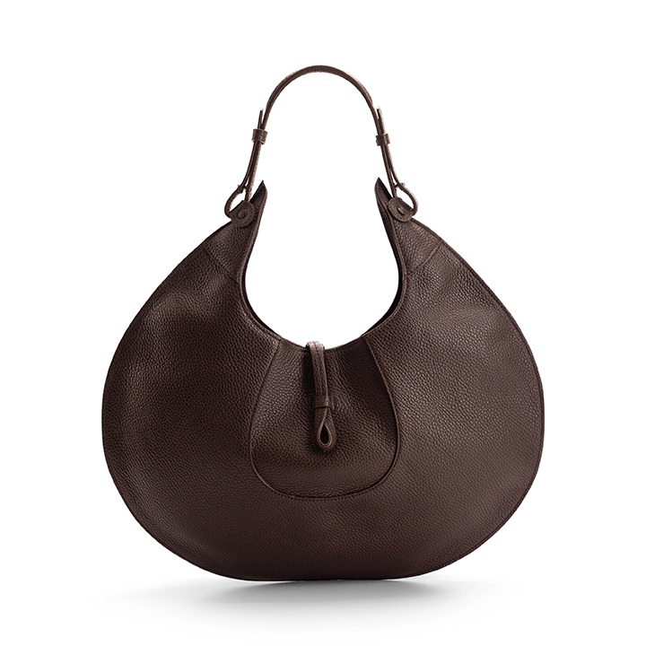 The back view of a brown luxury designer pebble calf tote bag, showcasing the curved designer silhouette against a white background.
