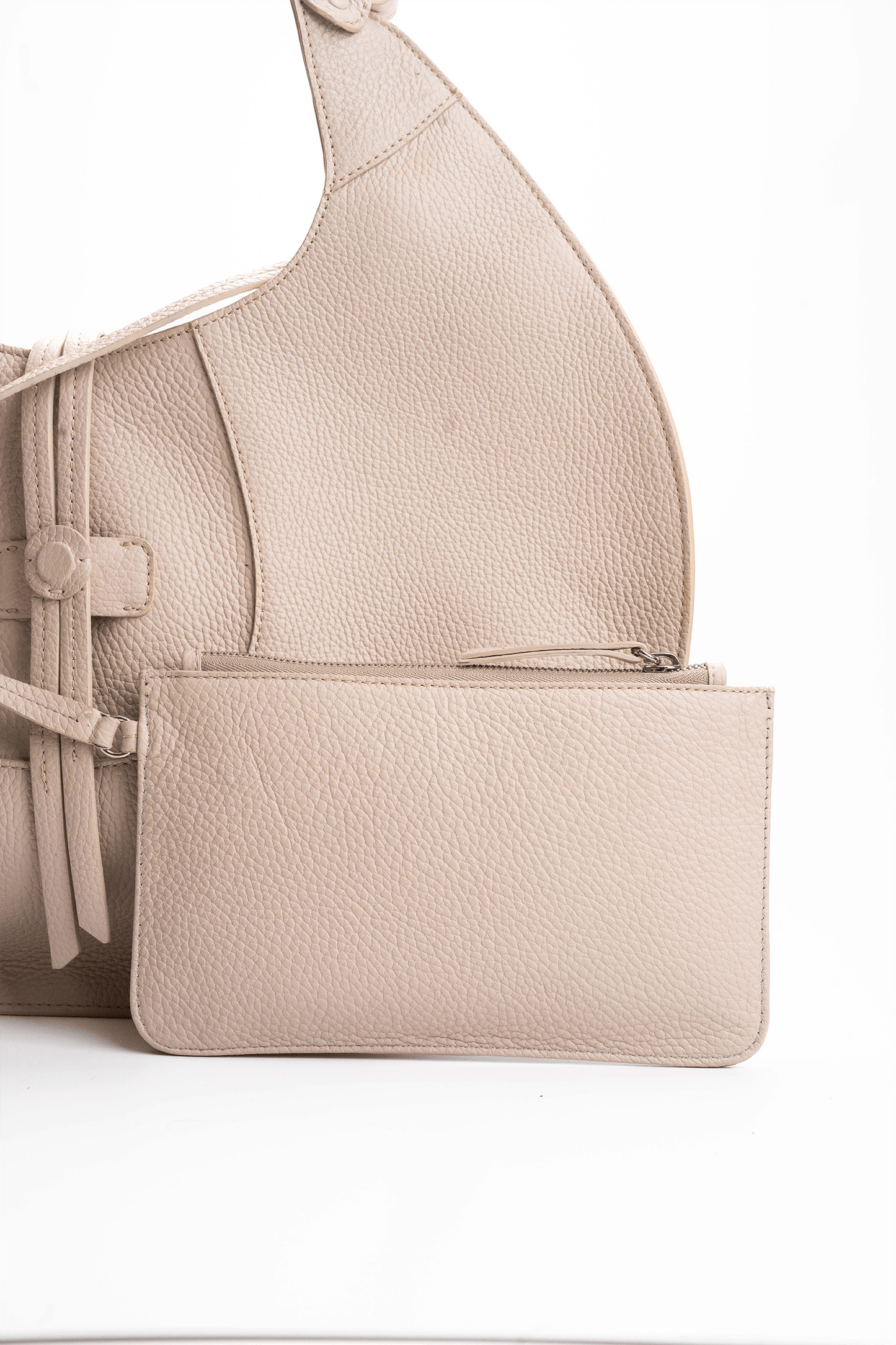 Front view of a beige luxury pebble calf tote bag with a matching small pouch attached by a strap, displayed on a white background.